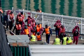A group of people thought to be migrants are brought in to the Border Force compound in Dover