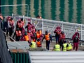 A group of people thought to be migrants are brought in to the Border Force compound in Dover