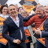 Scottish Liberal Democrat leader Alex Cole-Hamilton (left) with former leader Willie Rennie (centre) and Liberal Democrat leader Ed Davey (right) alongside newly-elected MSPs at Newhaven Lighthouse
