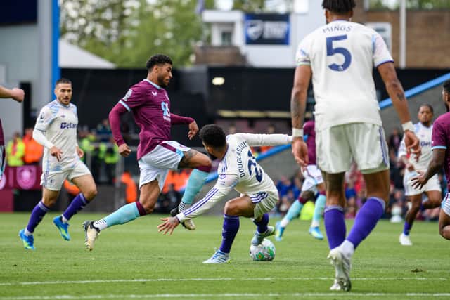 Josh Laurent is challenged by Douglas Luiz. Photo: Kelvin Lister-Stuttard
