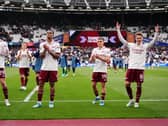 Arsenal players Martin Odegaard, Leandro Trossard, Gabriel and Kai Havertz celebrate in front of fans