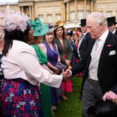 Charles greets guests during a garden party at Buckingham Palace