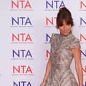 Davina McCall posing for photos in front of NTA signage