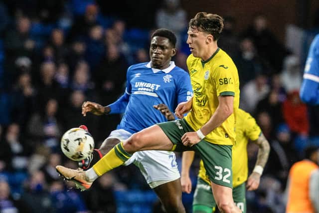 Rangers' Nasser Djiga (L) and Hibernian's Josh Campbell (R) in action