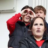 A Middlesbrough fan makes a binoculars gesture during the first leg of the Championship play-off semi-final first leg against Southampton