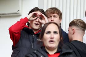 A Middlesbrough fan makes a binoculars gesture during the first leg of the Championship play-off semi-final first leg against Southampton