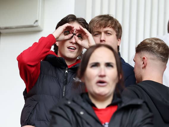 A Middlesbrough fan makes a binoculars gesture during the first leg of the Championship play-off semi-final first leg against Southampton