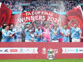 Manchester City players celebrate with the FA Cup trophy