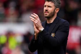 Manchester United manager Michael Carrick applauds the Old Trafford crowd