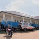 People wait near an ambulance at a hospital in Bunia, Democratic Republic of Congo