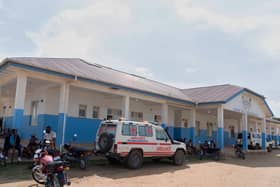 People wait near an ambulance at a hospital in Bunia, Democratic Republic of Congo