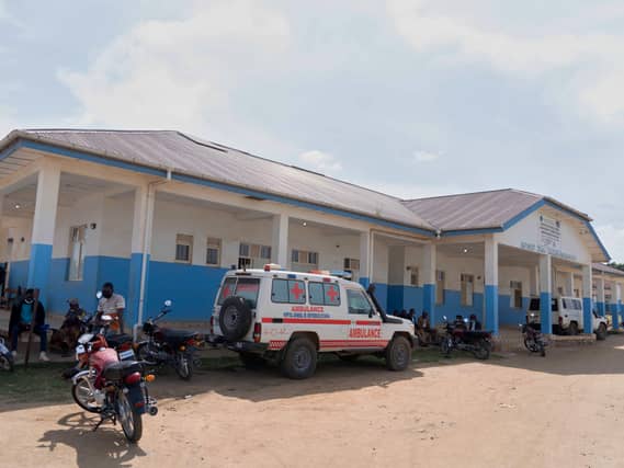 People wait near an ambulance at a hospital in Bunia, Democratic Republic of Congo