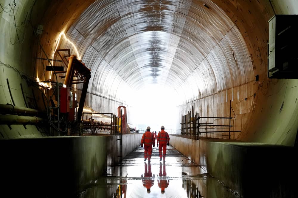 Members of HS2 staff walk through the Chilterns tunnel towards the tunnel exit at West Hyde, Hertfordshire, as the HS2 project continues
