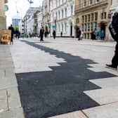 A tarmac patch on Colmore Row, next to the historic Council House and Town Hall on Victoria Square in Birmingham.