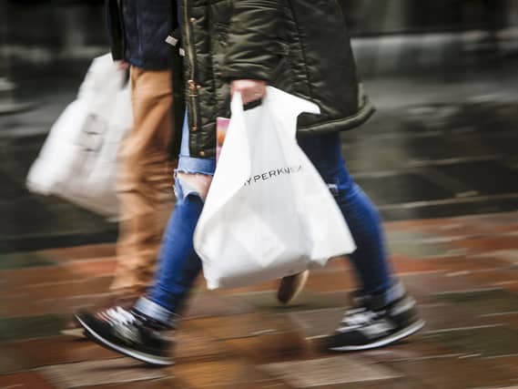 People carrying bags on a high street