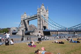 People relaxing in hot weather in Potters Fields Park, London