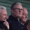 Sir Keir Starmer amongst a crowd in a stadium