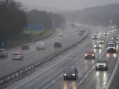 Vehicles drive through the rain on the M40 motorway near Warwick