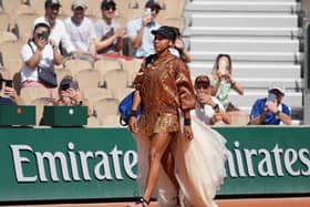Naomi Osaka walks onto court