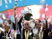 Alex Greenwood lifts the trophy