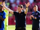 Andoni Iraola raises both arms in celebration