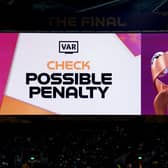 VAR checks for a possible penalty for a handball