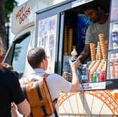 Members of the public purchase ice cream on London's Southbank during a heatwave on 12 August 2025.