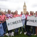 Campaigners in Westminster, central London, in July 2024 painted their breasts with messages calling for the breast cancer drug Enhertu to be made available on the NHS