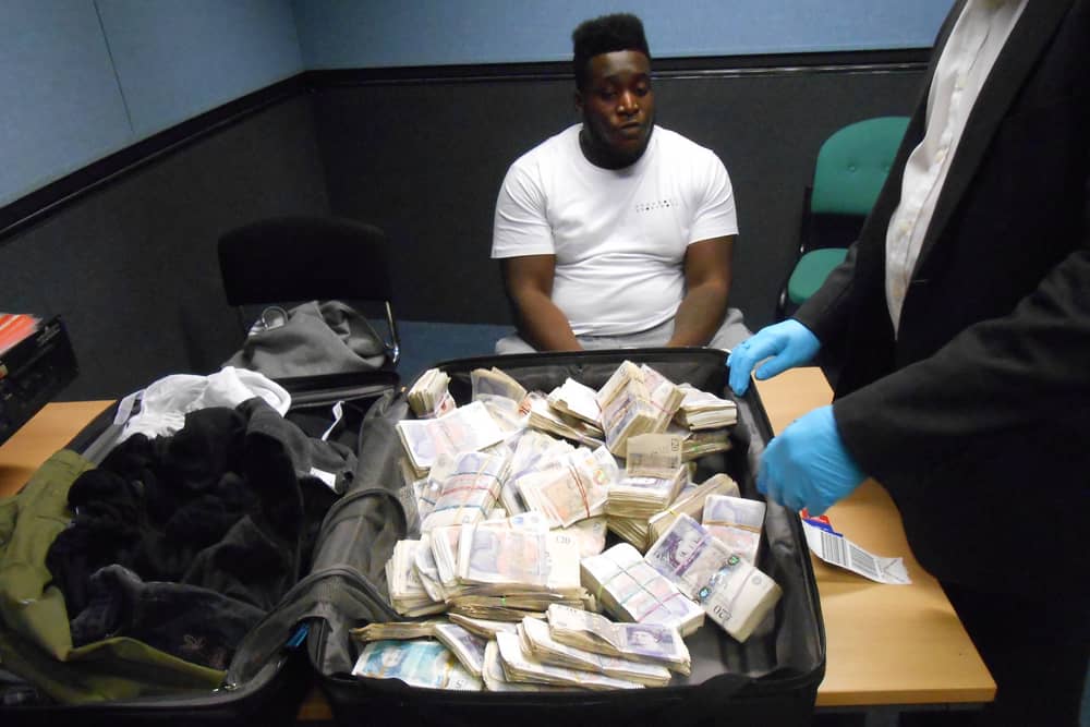 Sheldon Noel with a suitcase of cash. 