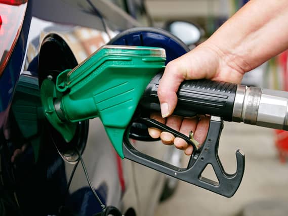Woman Filling a Car with Unleaded Petrol