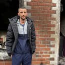 Jamie Corry outside his fire-damage house