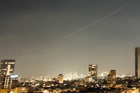 A projectile streaks through the sky over central Israel during an Iranian missile attack