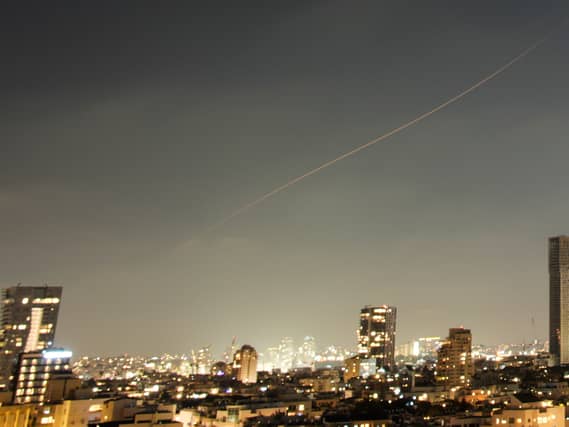 A projectile streaks through the sky over central Israel during an Iranian missile attack