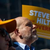 Steve Hilton in front of campaign placards