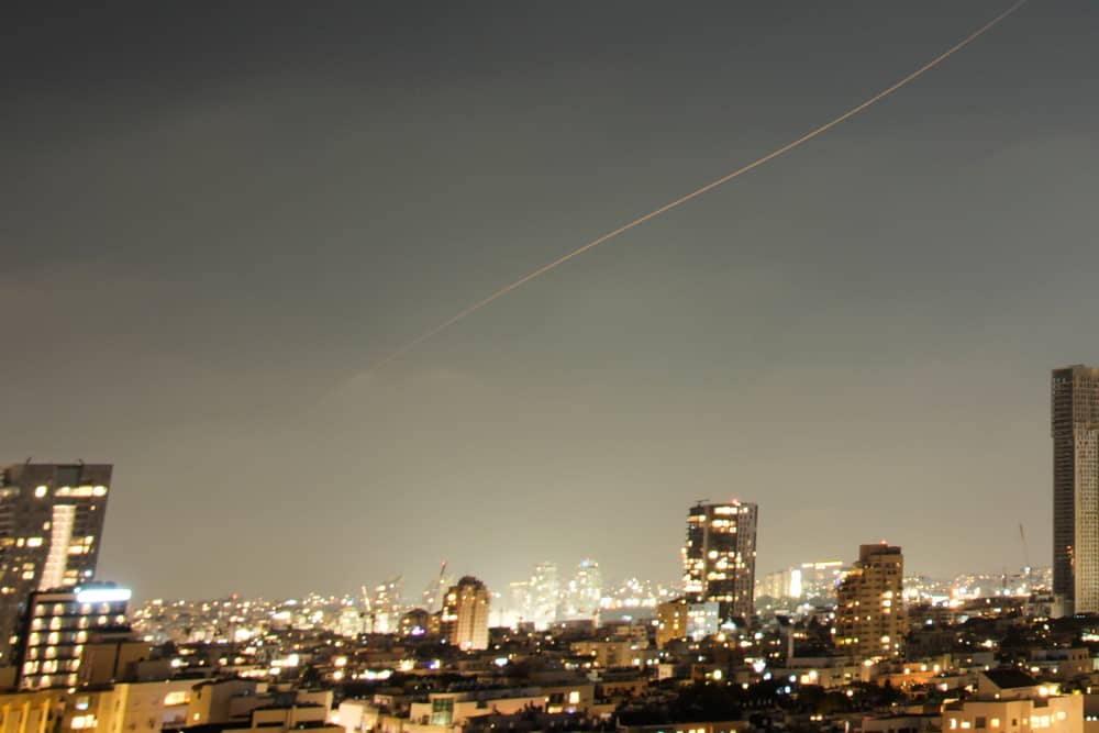 A projectile streaks through the sky over central Israel during an Iranian missile attack