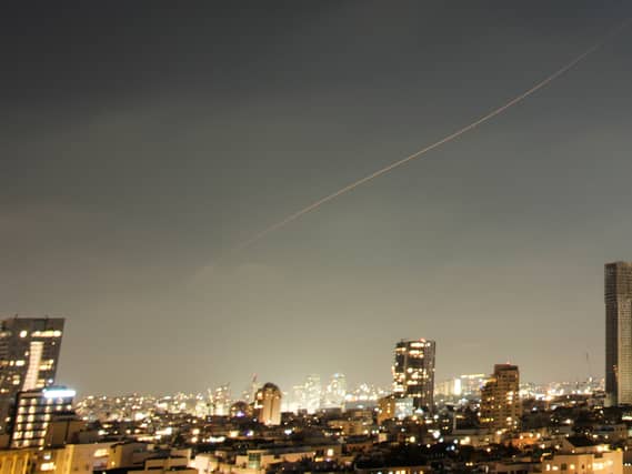 A projectile streaks through the sky over central Israel during an Iranian missile attack