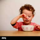 A child eating cereal.