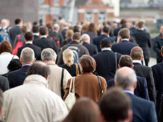 Large crowd of commuters on their way from work during rush hour in the City of London, England, UK