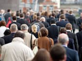 Large crowd of commuters on their way from work during rush hour in the City of London, England, UK