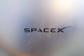 The SpaceX logo on a blurred window