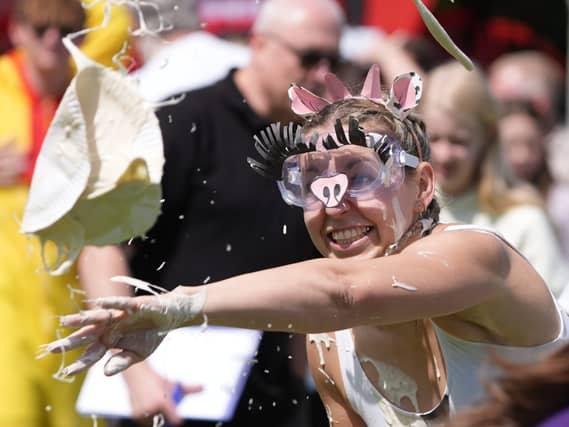 A woman throwing a custard pie