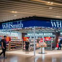 A WH Smith outlet, with shoppers inside and walking past