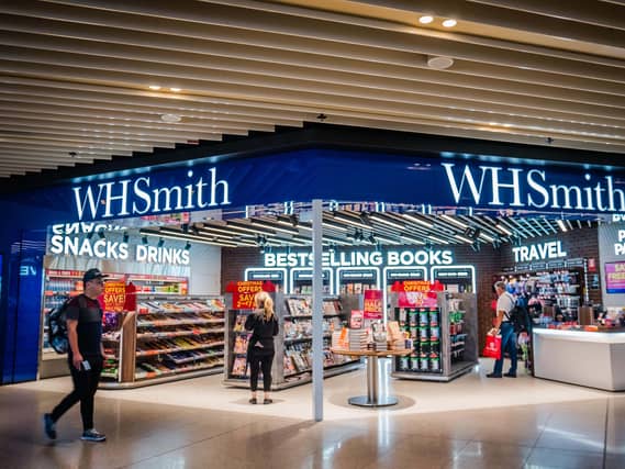 A WH Smith outlet, with shoppers inside and walking past
