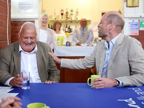 The Prince of Wales (right) speaks with Paul Gannon during a visit to Norfolk and Waveney Mind in Norwich