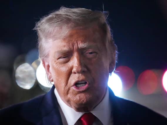 President Donald Trump talks with reporters before boarding Air Force One at John F. Kennedy International Airport in New York