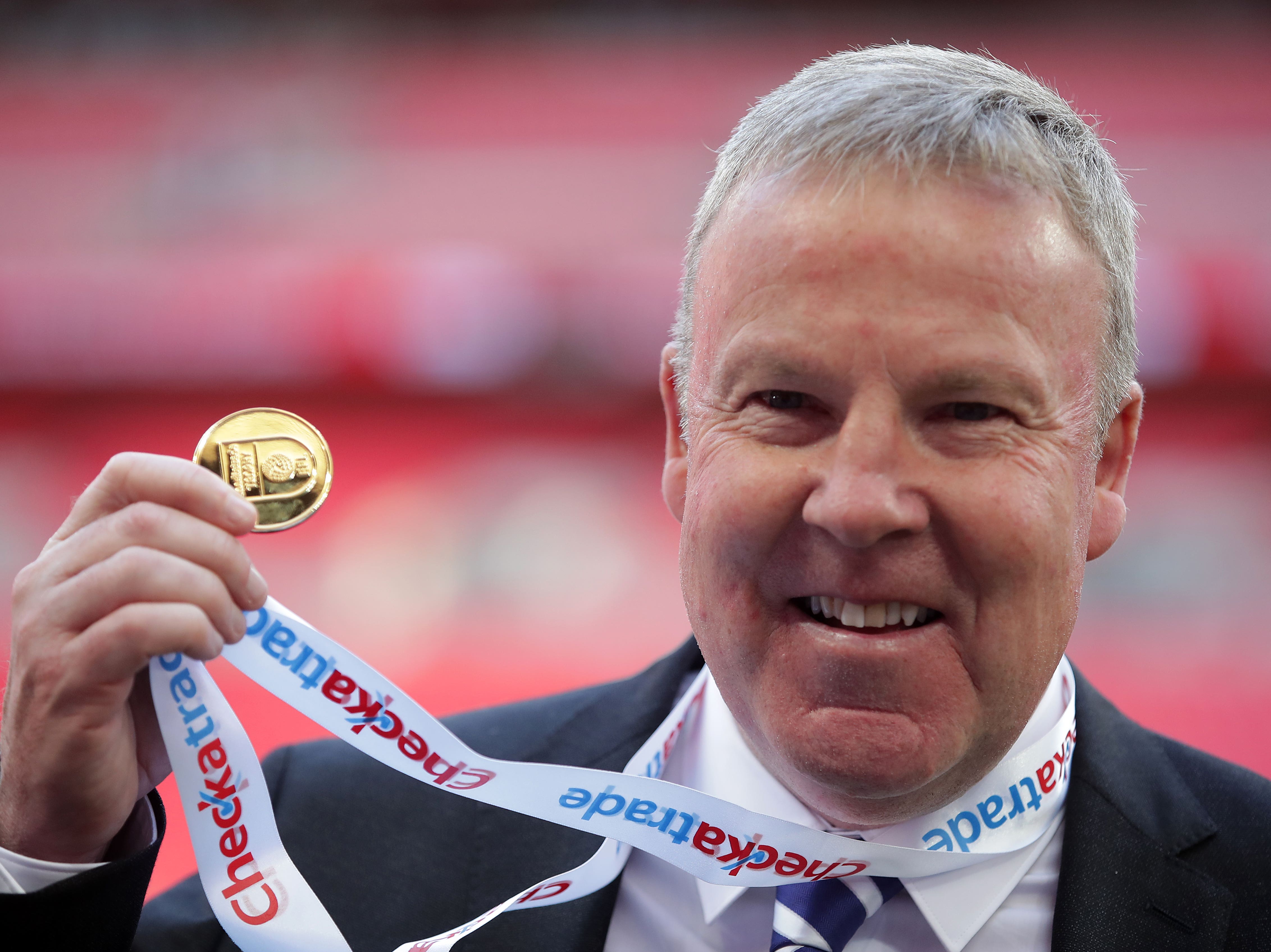 Kenny Jackett holds up his medal after winning the Checkatrade Trophy with Portsmouth