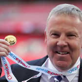 Kenny Jackett holds up his medal after winning the Checkatrade Trophy with Portsmouth