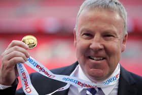 Kenny Jackett holds up his medal after winning the Checkatrade Trophy with Portsmouth