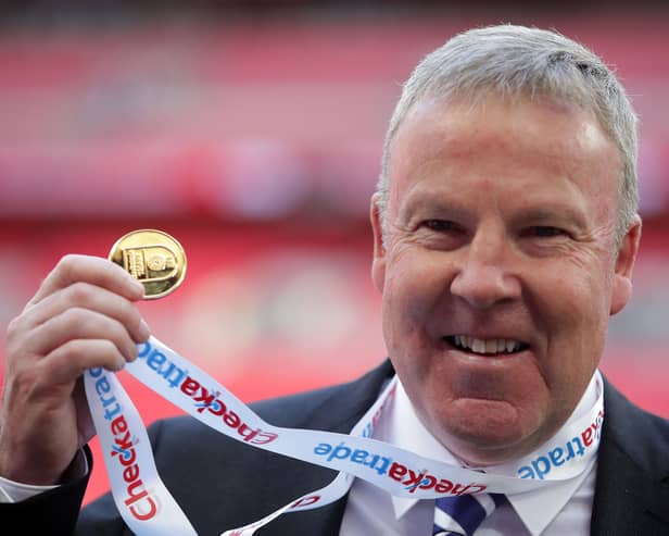 Kenny Jackett holds up his medal after winning the Checkatrade Trophy with Portsmouth