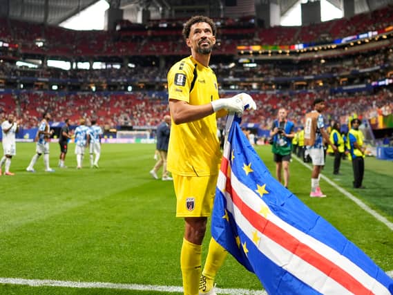 Vozinha holds a Cape Verde flag after the draw with Spain